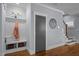 Hallway with storage bench, closet, hardwood flooring, and a view of staircase with decorative clock at 608 Dowd St, Durham, NC 27701