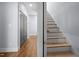 Hallway with hardwood floors, staircase and gray doors at 608 Dowd St, Durham, NC 27701