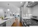 Open-concept kitchen features stainless steel appliances, granite countertops, and modern gray cabinetry at 608 Dowd St, Durham, NC 27701