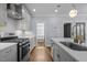 Well-designed kitchen equipped with stainless steel gas range, white countertops, and ample cabinet space at 608 Dowd St, Durham, NC 27701