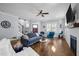 Bright living room boasts hardwood floors, a cozy seating area, a ceiling fan, and a fireplace with TV at 608 Dowd St, Durham, NC 27701