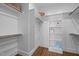 Spacious walk-in closet with wooden floors, shelves, hanging rods, and ample storage space at 608 Dowd St, Durham, NC 27701