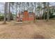 View of a brick house in the backyard at 636 Palmer Dr, Sanford, NC 27330