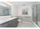Bright bathroom with a double vanity, modern tile, and glass shower doors at 636 Palmer Dr, Sanford, NC 27330