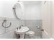 Elegant powder room features marble tiling, pedestal sink, and classic fixtures at 636 Palmer Dr, Sanford, NC 27330