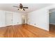 Spacious bedroom with hardwood floors, white walls, and a ceiling fan at 636 Palmer Dr, Sanford, NC 27330