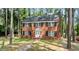Charming two-story brick home with a well-manicured lawn and mature trees at 636 Palmer Dr, Sanford, NC 27330