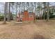 Brick home with a well-manicured lawn and an abundance of tall trees at 636 Palmer Dr, Sanford, NC 27330