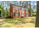 Traditional brick two-story home with black shutters and well-maintained landscaping in wooded area at 636 Palmer Dr, Sanford, NC 27330