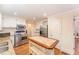 Bright kitchen features granite countertops, stainless steel appliances, and a butcher block island at 636 Palmer Dr, Sanford, NC 27330