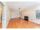 Spacious living room with hardwood floors, fireplace, large windows, and stylish light fixture at 636 Palmer Dr, Sanford, NC 27330