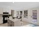 Bright kitchen features a kitchen island with a breakfast bar, and backyard views at 7 Hampton Hill Pl, Chapel Hill, NC 27517