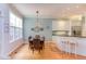 Well-lit dining room with a large window, table, and bar seating area near the kitchen at 705 Highgrove Dr, Chapel Hill, NC 27516