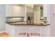 Kitchen featuring bar seating with white cabinets, stainless steel appliances, and granite countertops at 705 Highgrove Dr, Chapel Hill, NC 27516