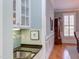 Wet bar area showcasing granite countertop, tile backsplash, and direct access to the dining room at 705 Highgrove Dr, Chapel Hill, NC 27516