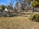 A spacious backyard with mature trees and landscaping offers a serene outdoor space at 707 Memorial Ave, Dunn, NC 28334