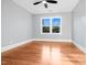 Bright, airy bedroom with hardwood floors and a large window offering exterior views at 707 Memorial Ave, Dunn, NC 28334