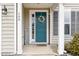 Inviting front entryway with a teal door, decorative wreath, and covered porch at 708 Pitchback Mill Ct Ct, Wake Forest, NC 27587