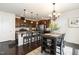 Spacious kitchen with dark wood cabinets, granite countertops, and a breakfast bar seating area at 708 Pitchback Mill Ct Ct, Wake Forest, NC 27587