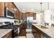 Gourmet kitchen boasts granite countertops, stainless steel appliances, and dark wood cabinetry at 708 Pitchback Mill Ct Ct, Wake Forest, NC 27587