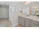 This bathroom features a neutral color palette and a spacious vanity with gray cabinetry at 724 Bracklyn Ave, Zebulon, NC 27597