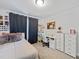 Comfortable bedroom with neutral carpet and a light color palette and a small desk area at 724 Bracklyn Ave, Zebulon, NC 27597