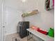 Well-organized laundry room with modern washer and dryer, shelving, and ample counter space for efficient chores at 724 Bracklyn Ave, Zebulon, NC 27597