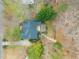 An aerial view showcasing the property's setting surrounded by trees and landscaping at 7805 Fairlake Dr, Wake Forest, NC 27587