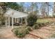 Landscaped backyard featuring a gazebo, a patio, bushes, mulch, and gravel at 7805 Fairlake Dr, Wake Forest, NC 27587