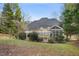 Spacious backyard view of the exterior featuring a patio, wooden deck, and mature trees, creating a relaxing atmosphere at 7805 Fairlake Dr, Wake Forest, NC 27587