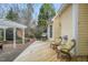 The backyard features a wooden deck, chairs, a grill, yellow siding, and a gazebo at 7805 Fairlake Dr, Wake Forest, NC 27587