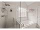 Spa-like bathroom with glass shower, soaking tub, decorative window, and tiled walls at 7805 Fairlake Dr, Wake Forest, NC 27587