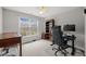 Bright bedroom featuring a window, a desk, a bookcase, and a comfortable chair at 7805 Fairlake Dr, Wake Forest, NC 27587
