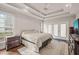Spacious bedroom featuring hardwood floors, trey ceiling, ceiling fan, and access to a private balcony at 7805 Fairlake Dr, Wake Forest, NC 27587