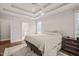 Spacious bedroom featuring hardwood floors, trey ceiling, and ensuite bathroom with glass shower at 7805 Fairlake Dr, Wake Forest, NC 27587