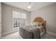 Cozy bedroom featuring a decorative headboard, soft bedding, and a ceiling fan at 7805 Fairlake Dr, Wake Forest, NC 27587
