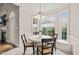 Charming breakfast nook with white wainscoting, large windows, and views of the outdoors at 7805 Fairlake Dr, Wake Forest, NC 27587