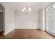 Formal dining room with hardwood floors, chandelier, and wainscoting at 7805 Fairlake Dr, Wake Forest, NC 27587