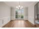 Elegant dining room featuring large window, hardwood floors, and decorative trim at 7805 Fairlake Dr, Wake Forest, NC 27587