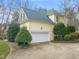 Charming two-story home with a two car garage, driveway and manicured landscaping at 7805 Fairlake Dr, Wake Forest, NC 27587