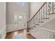 Grand foyer with hardwood floors, a decorative front door, and staircase at 7805 Fairlake Dr, Wake Forest, NC 27587