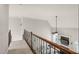 Upstairs hallway featuring decorative railing overlooking the living room below at 7805 Fairlake Dr, Wake Forest, NC 27587