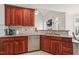 Kitchen featuring wood cabinets, granite counters, stainless steel dishwasher, and tile floors at 7805 Fairlake Dr, Wake Forest, NC 27587