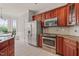 Charming kitchen with stainless appliances, wood cabinets, granite counters, and a bright breakfast nook at 7805 Fairlake Dr, Wake Forest, NC 27587