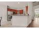 Bright kitchen with white walls, wood cabinets, granite counters, stainless steel appliances, and tile flooring at 7805 Fairlake Dr, Wake Forest, NC 27587