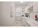 Functional laundry room with washer, dryer, utility sink and storage cabinets at 7805 Fairlake Dr, Wake Forest, NC 27587