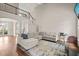 Spacious living room with comfortable sectional couch, hardwood floors and staircase at 7805 Fairlake Dr, Wake Forest, NC 27587