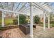 Cozy outdoor patio with white pergola, wicker seating, and landscaped surroundings at 7805 Fairlake Dr, Wake Forest, NC 27587