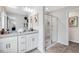 Modern bathroom with dual vanity sinks, granite countertops, and a glass-enclosed shower at 8715 Wardle Ct, Raleigh, NC 27616
