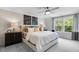 Calm bedroom with a comfortable bed, stylish furnishings, and natural light from the windows at 8715 Wardle Ct, Raleigh, NC 27616